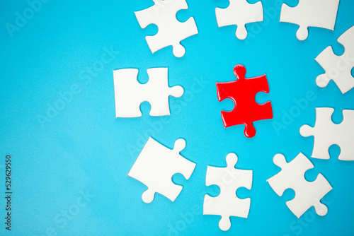 White part of jigsaw puzzle pieces on blue background. concepts of problem solving, business success, teamwork, Team playing jigsaw game incomplete, Texture photo with copy space for text