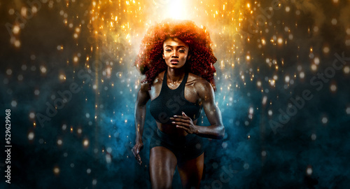 A strong athletic, female sprinter, running at sunrise wearing in the sportswear, fitness and sport motivation concept with copy space.
