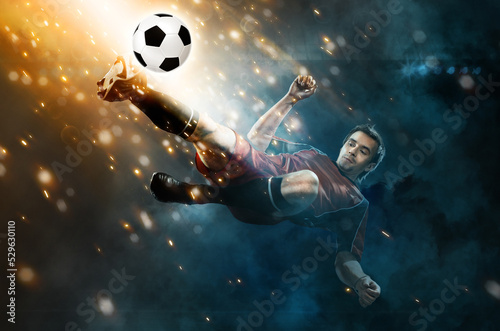 Football player. Soccer player. Man in football sportswear at the game in action with ball. Sport concept. © Mike Orlov