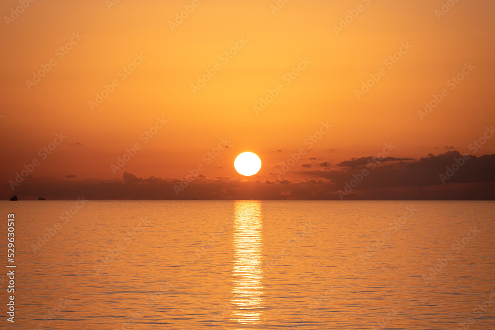 Beautiful, golden sunset over the calm ocean.