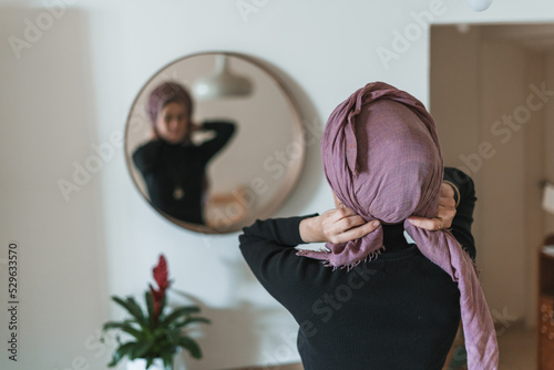 Fototapeta Jewish religious woman ties a shawl around her head