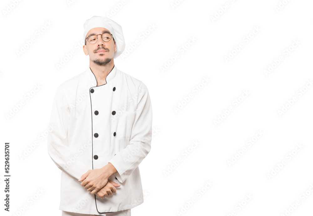 Tired young chef doing a gesture of boredom