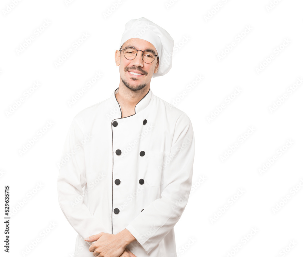 Happy young chef posing against background Happy young chef posing against background