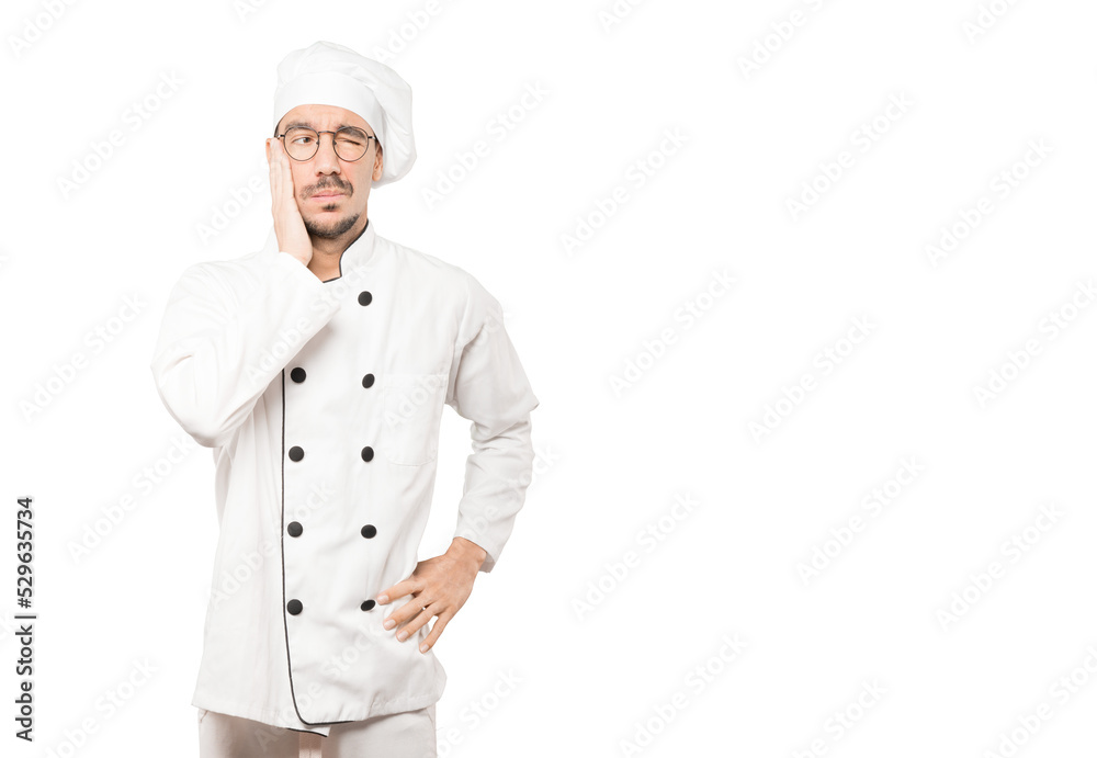 Concerned young chef doing a gesture of relief Concerned young chef doing a gesture of relief