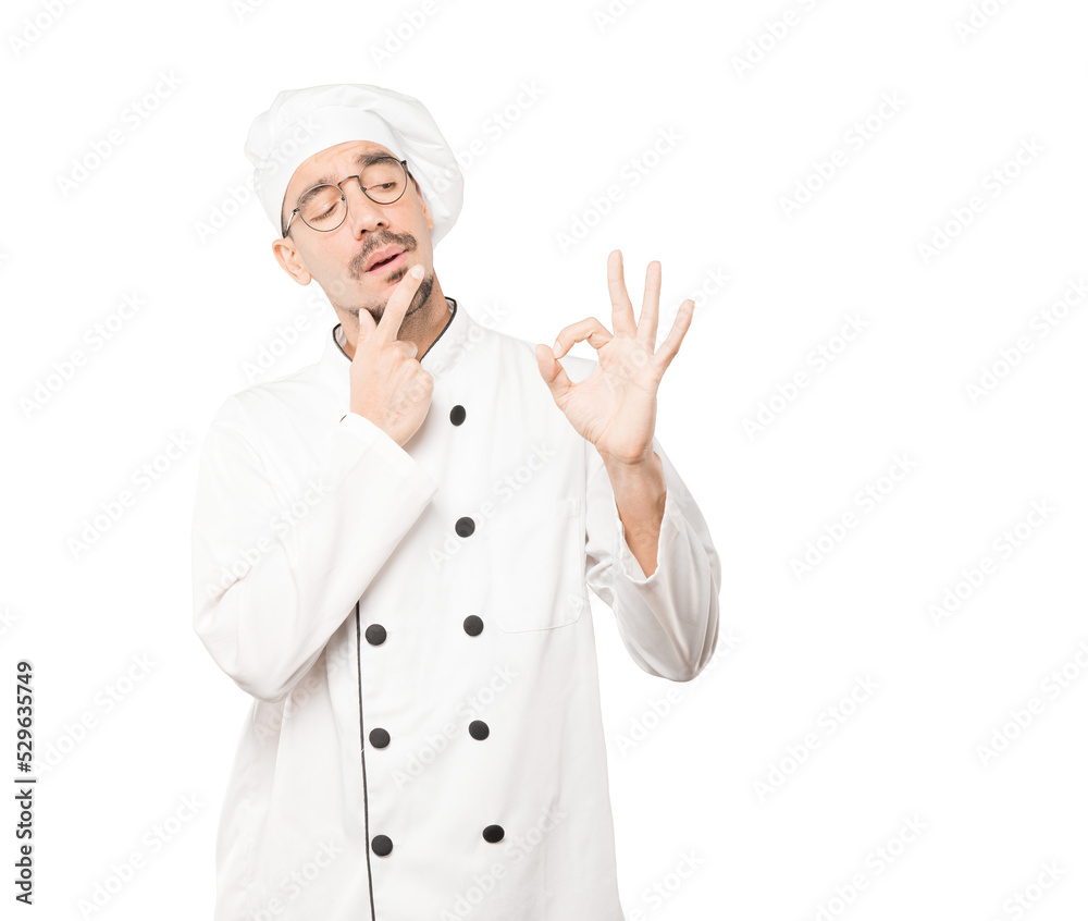 Worried young chef doubting and making a gesture of approval