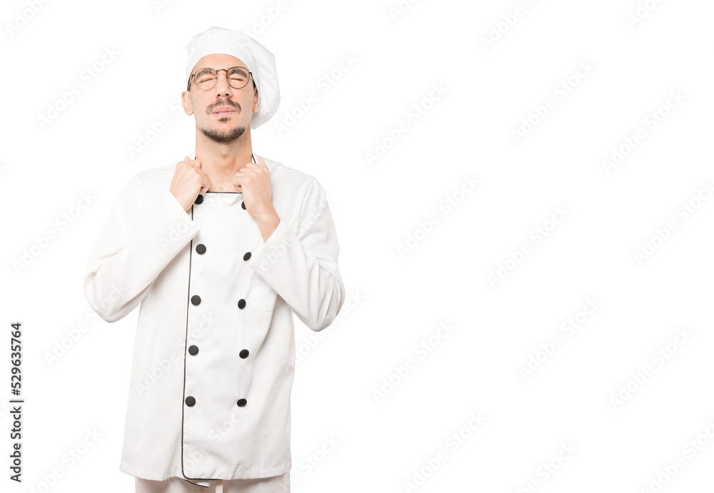 Depressed young chef doing a gesture of stress Depressed young chef doing a gesture of stress