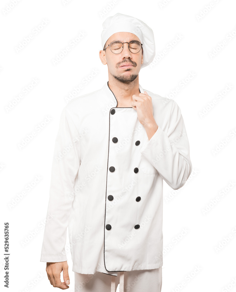 Depressed young chef doing a gesture of stress Depressed young chef doing a gesture of stress
