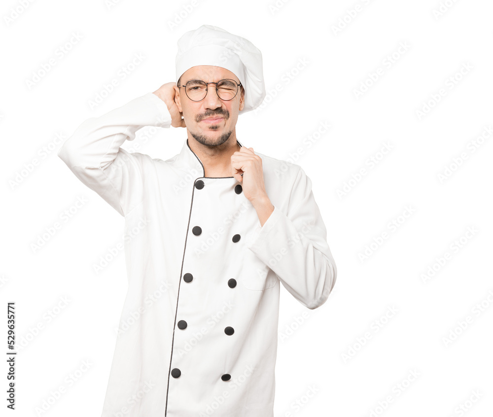 Depressed young chef doing a gesture of stress Depressed young chef doing a gesture of stress