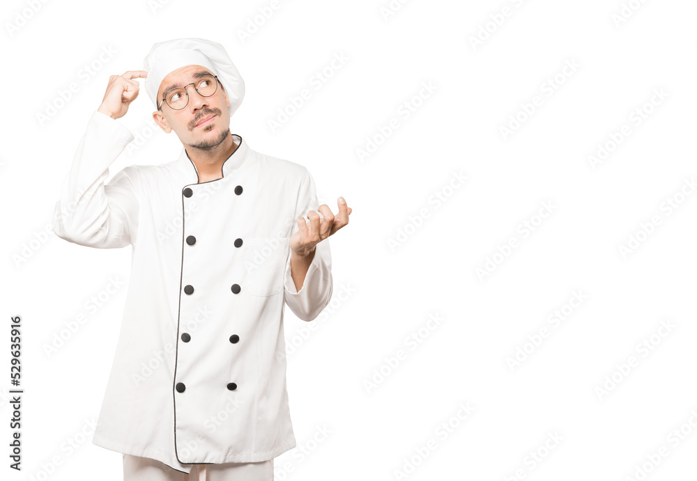 Concerned young chef doing a gesture of confusion