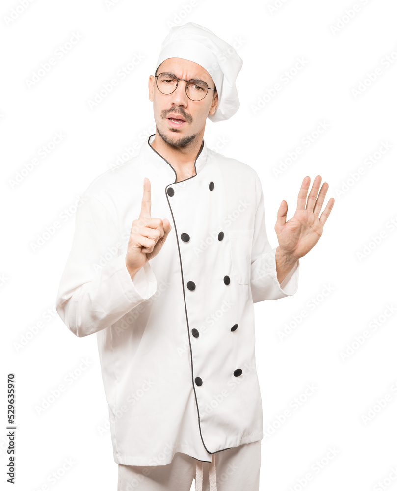 Haughty young chef making a contemptuous gesture Haughty young chef making a contemptuous gesture