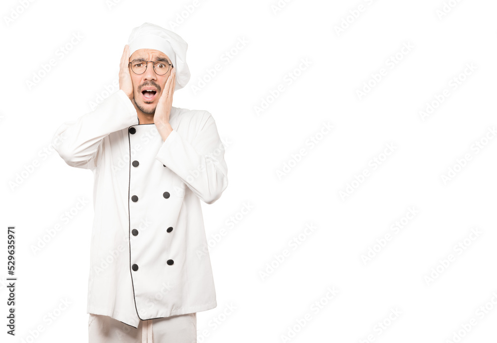 Crazy young chef making a gesture of despair