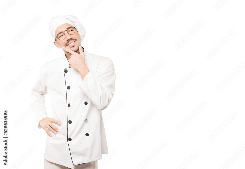 Happy young chef making a gesture of doubt