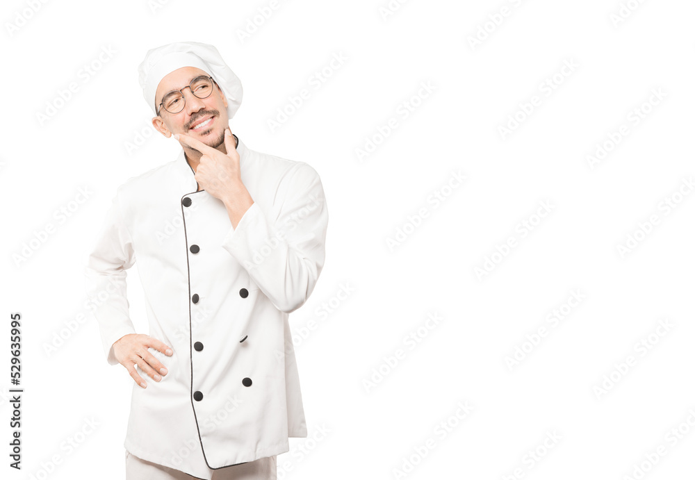 Happy young chef making a gesture of doubt Happy young chef making a gesture of doubt