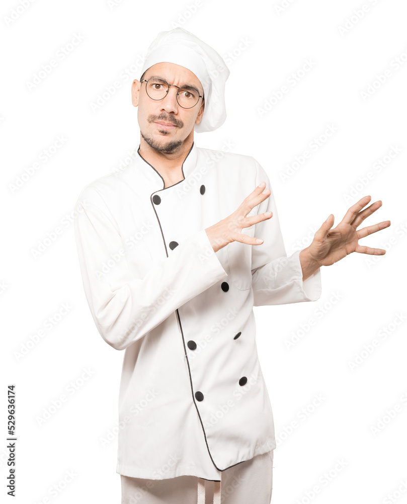 Scared young chef screaming against background Scared young chef screaming against background