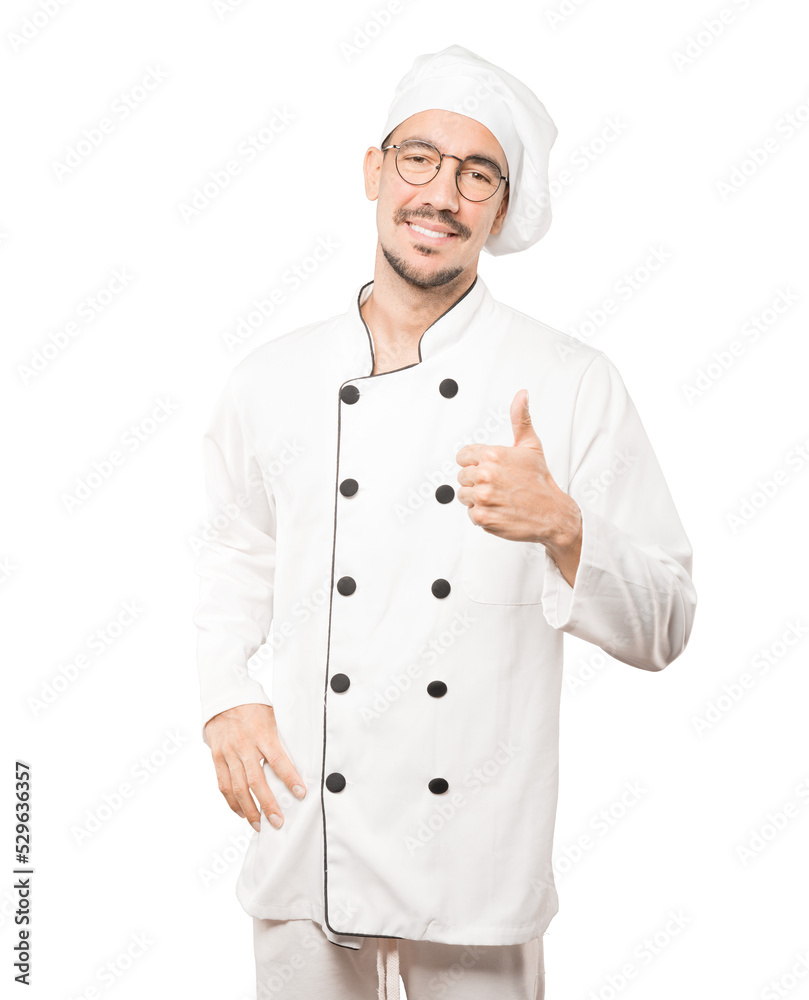 Happy young chef gesturing that everything is fine Happy young chef gesturing that everything is fine