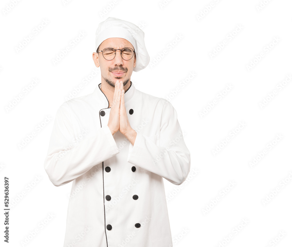 Happy young chef praying gesture Happy young chef praying gesture