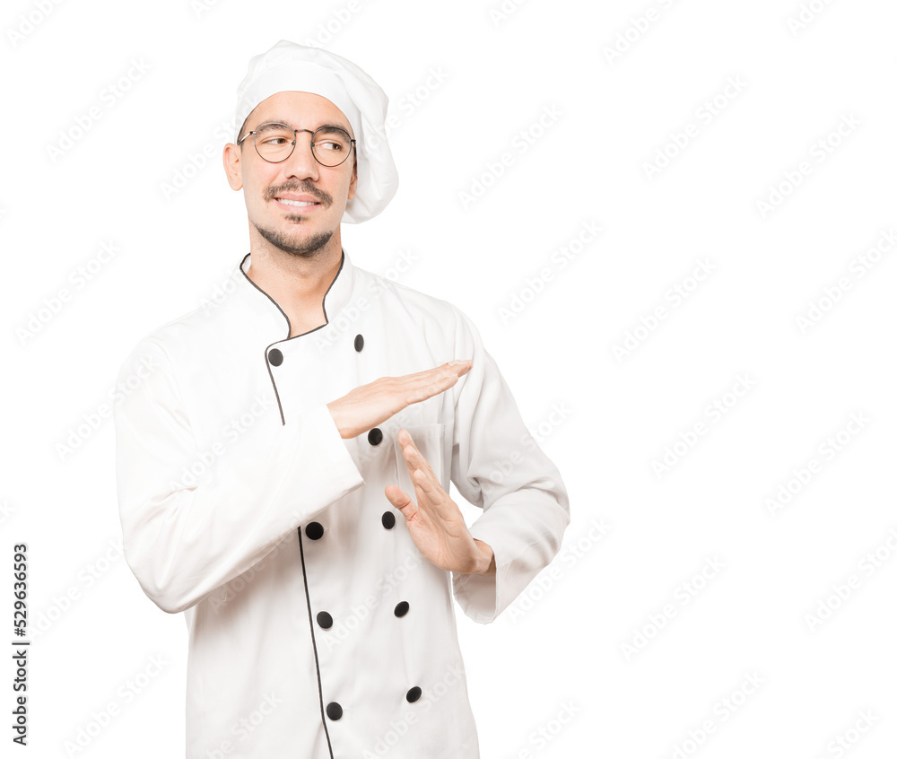 Stressed young chef making a time out gesture with his hands Stressed young chef making a time out gesture with his hands