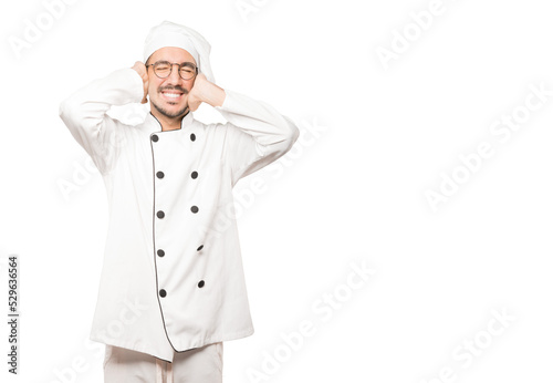 Young chef worried about loud noises and covering his ears