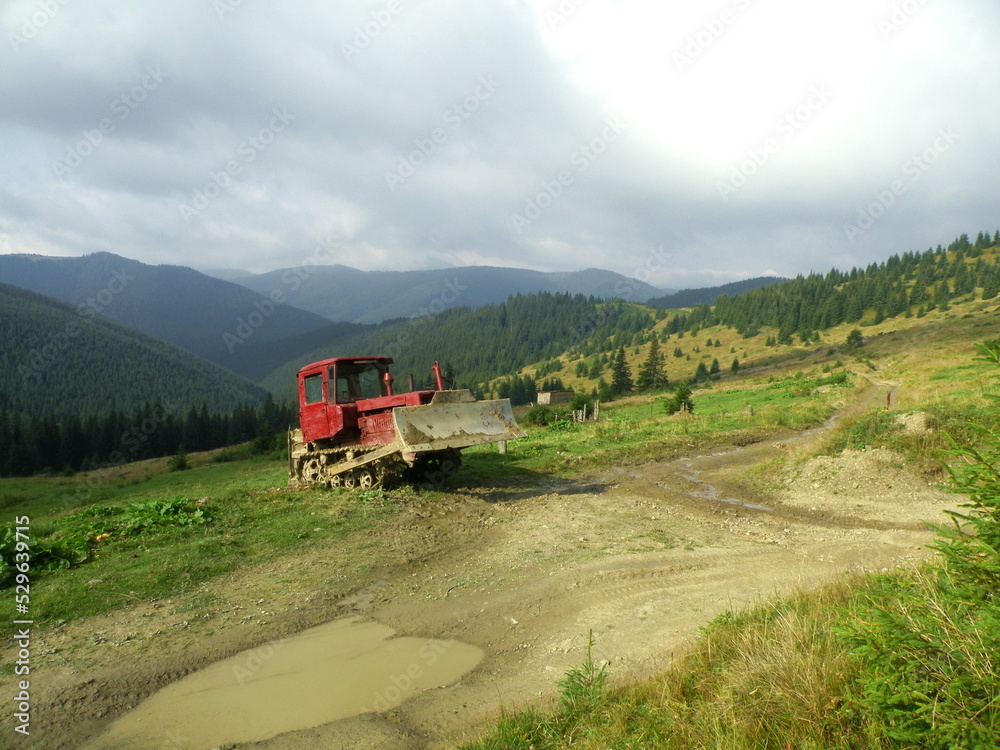 The road in the mountains will be built with a bulldozer