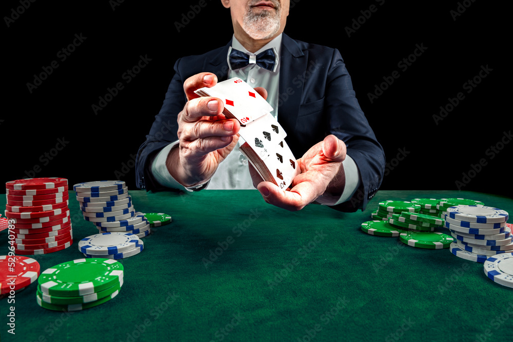 Croupier or casino dealer at gambling club or casino. Close up of male hand. Gambling concept Croupier or casino dealer at gambling club or casino. Close up of male hand. Gambling concept