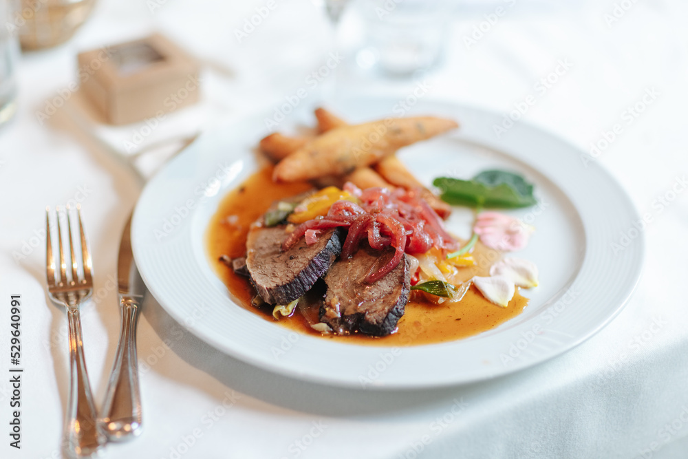 Delicious dinner beautifully arranged on a dinner plate.