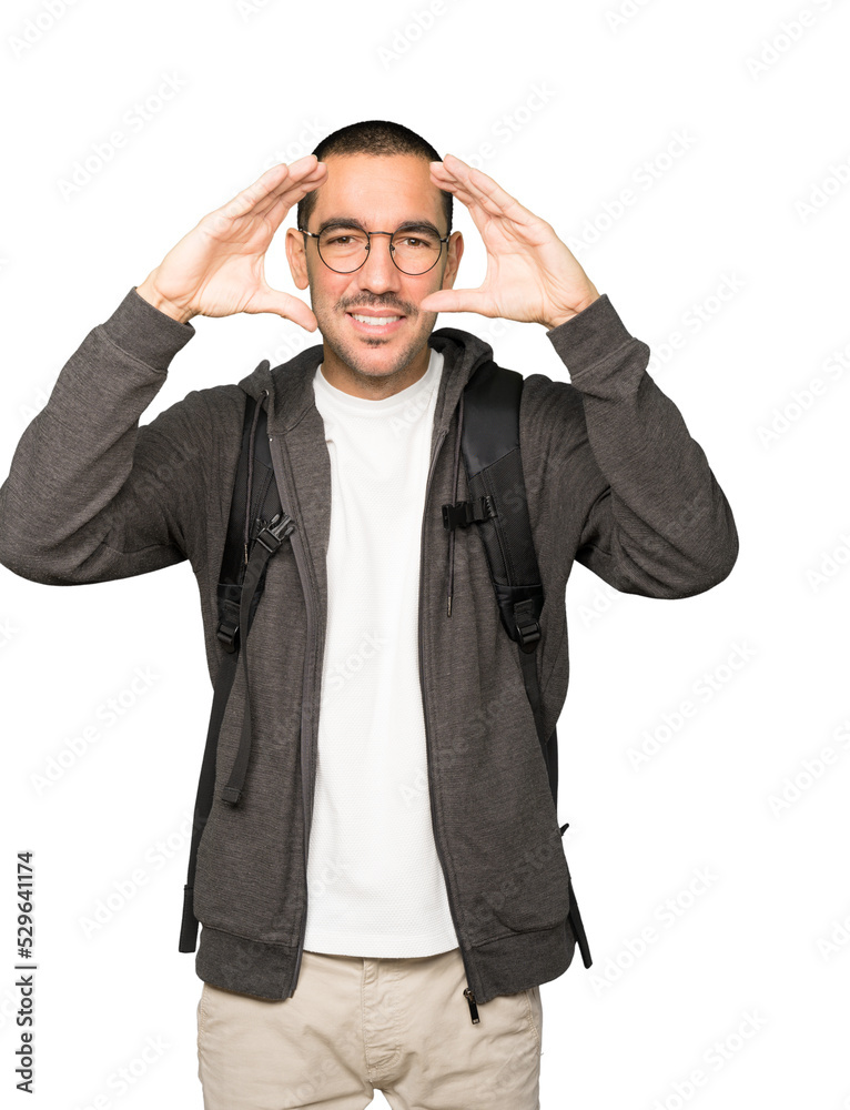 Amazed student using his hands like a binoculars Amazed student using his hands like a binoculars