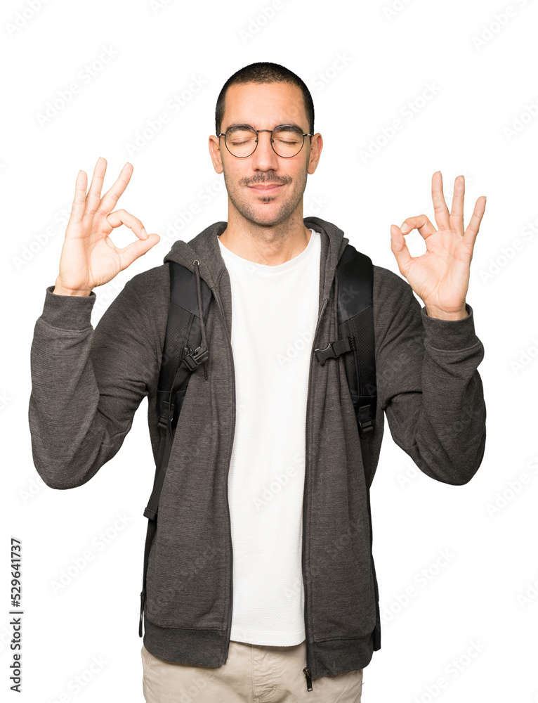 Happy student doing a gesture of meditation Happy student doing a gesture of meditation