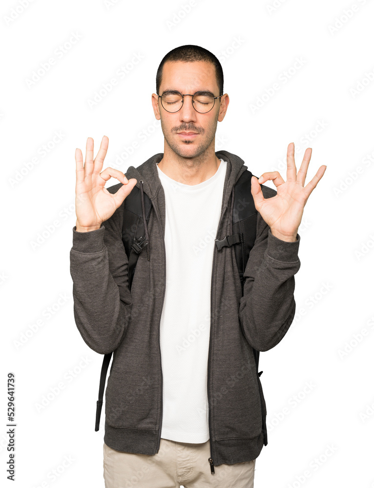 Happy student doing a gesture of meditation Happy student doing a gesture of meditation