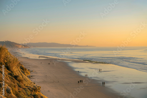 Panoramic beach view at Del Mar Southern California with people enjoying the sunset photo