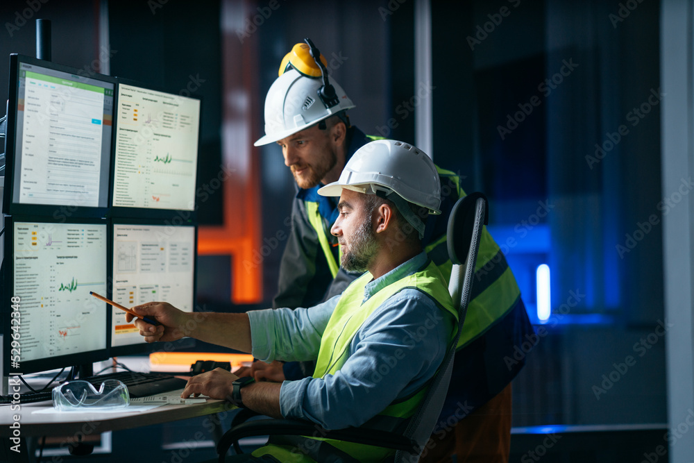 Group of  engineer control process of production uses computer with modern SCADA system which showing AI and machine learning. Team of workers operator follow of industry process on factory