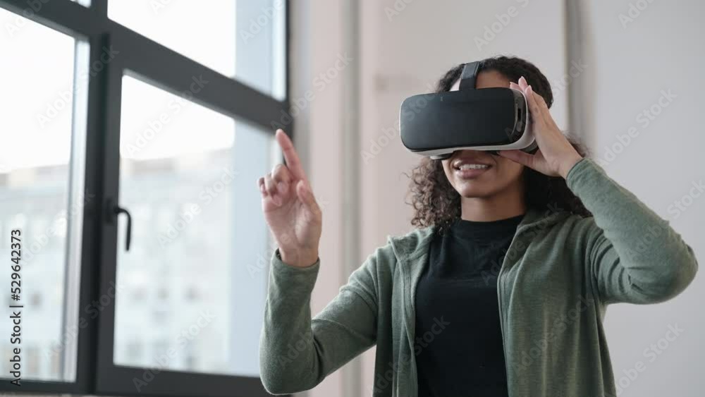 Young woman using virtual reality headset at home, VR, future, gadgets, technology, virtual event, education, study, learning, video game concept. Young woman using virtual reality headset at home, VR, future, gadgets, technology, virtual event, education, study, learning, video game concept.