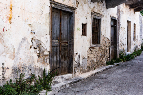 Narrow and colorful street in the village of Kritsa in the island of Crete. White street, beautiful traditional housing in Greece. 