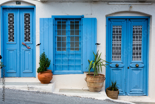 Narrow and colorful street in the village of Kritsa in the island of Crete. White street, beautiful traditional housing in Greece. 