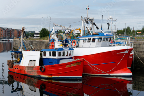 Trawler fishing red boat at Peterhead harbour in Scotland