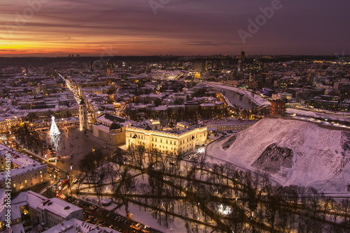 Beautiful Vilnius city panorama in winter with snow covered houses  churches and streets. Aerial evening view. Winter city scenery in Lithuania.