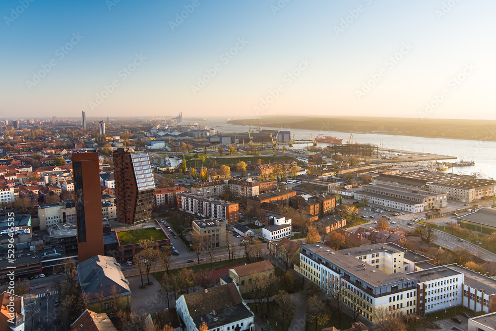 Scenic aerial view of the Old town of Klaipeda, Lithuania in golden evening light. Klaipeda city port area and it's surroundings on autumn day.