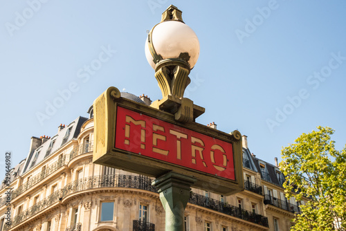 Paris, France. August 2022. Traditional Paris metro sign with buildings in the background