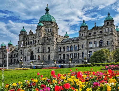 Legislative Assembly of British Columbia and beautiful colorful flowers in a garden photo