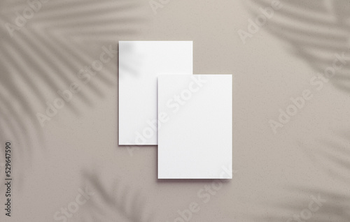 Two vertical postcard mockup blank paper template with overlay palm shadow on a neutral background. White empty card for design in 3D rendering photo