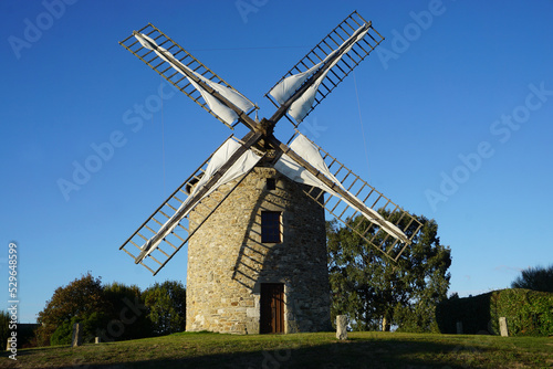 old stone windmill in the countryside in brittany france