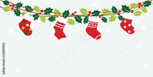 Christmas bunting with holly leaves  and socks on winter background
