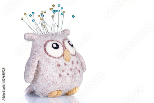 pincushion in the form of an owl on a white background photo