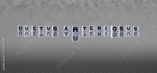 ductus arteriosus word or concept represented by black and white letter cubes on a grey horizon background stretching to infinity photo