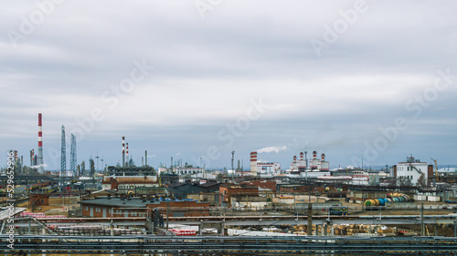 View of the oil refinery. Production equipment at a petrochemical plant. Oil refining production. Smoke from the pipes at the factory. Oil refining and gasoline production.