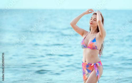 Sexy beautiful woman wearing bikini with beach hat show happy with eating water melon fruit on beach is holiday summer concept.