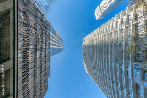 Looking up at residential buildings in Austin Texas against vibrant blue sky