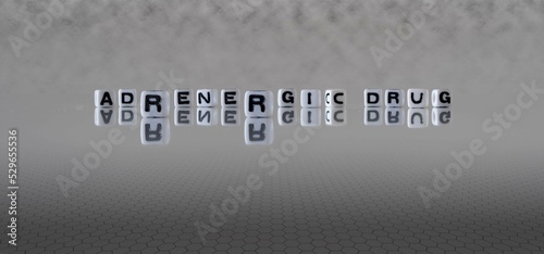 adrenergic drug word or concept represented by black and white letter cubes on a grey horizon background stretching to infinity photo