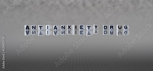 antianxiety drug word or concept represented by black and white letter cubes on a grey horizon background stretching to infinity