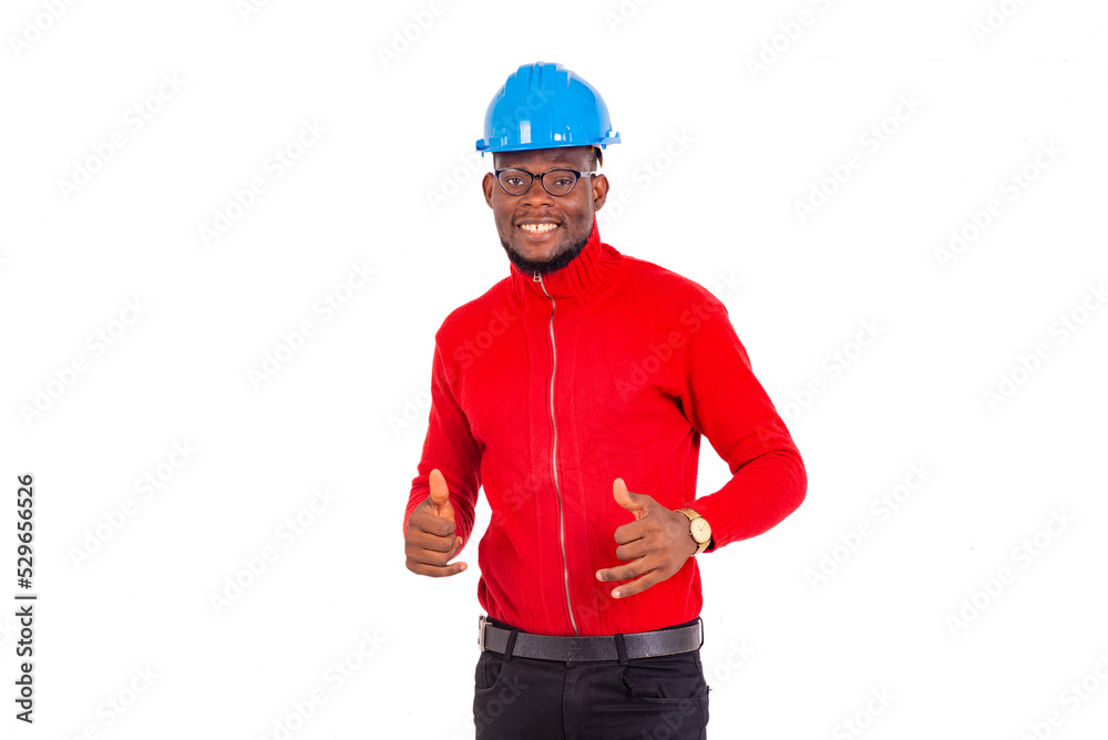 young male construction engineer showing his thumbs up smiling. young male construction engineer showing his thumbs up smiling.