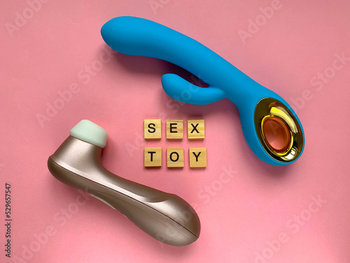Sex toys for woman. Two vibrators on a pink background. lettering SEX TOY. Useful for adults, sex shop